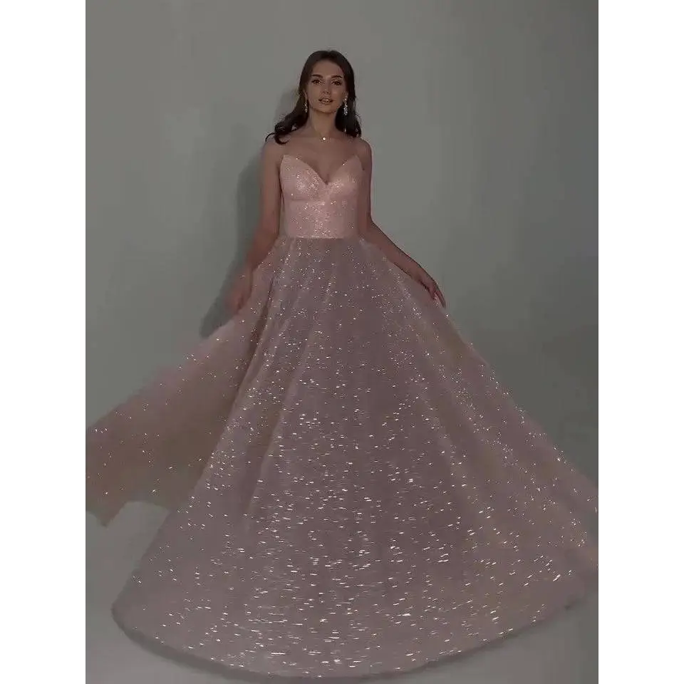 A shimmering blush pink sequined backless evening dress with fitted bodice and voluminous glitter-dusted skirt
