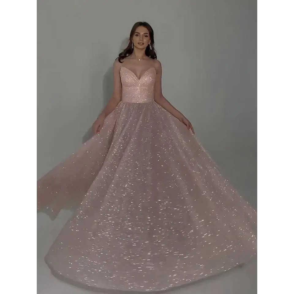 A blush sequined backless evening dress featuring a shimmering bodice and glitter-dusted tulle skirt