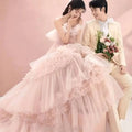 A blush pink photography pettiskirt colored mesh dress with multi-tiered ruffled layers and a sweetheart neckline