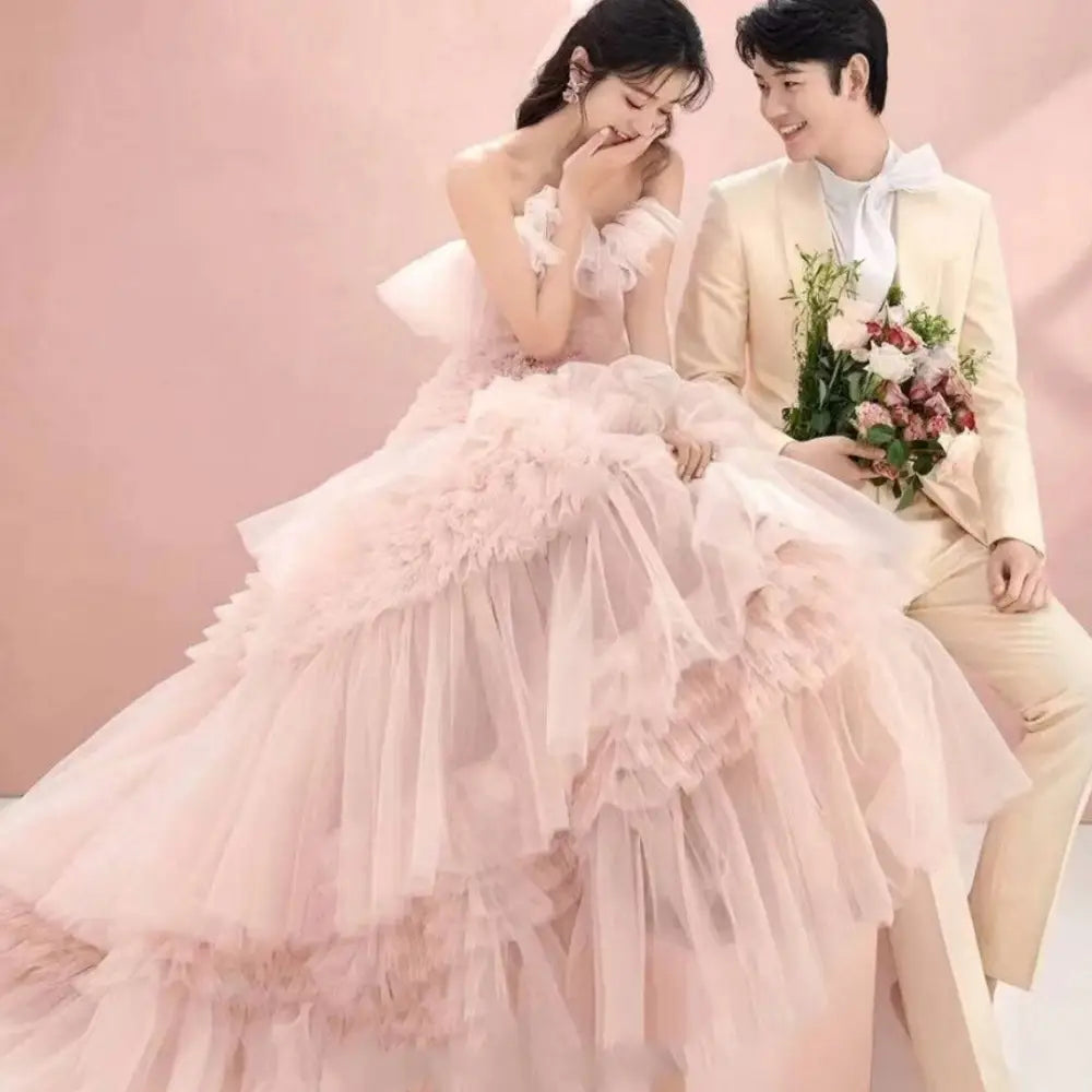 A blush pink photography pettiskirt colored mesh dress with multi-tiered ruffled layers and a sweetheart neckline