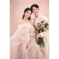 A delicate blush tiered photography pettiskirt colored mesh dress with a voluminous off-the-shoulder sweetheart neckline