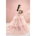 A blush pink tiered photography pettiskirt colored mesh dress with ruffled layers and off-the-shoulder sweetheart neckline