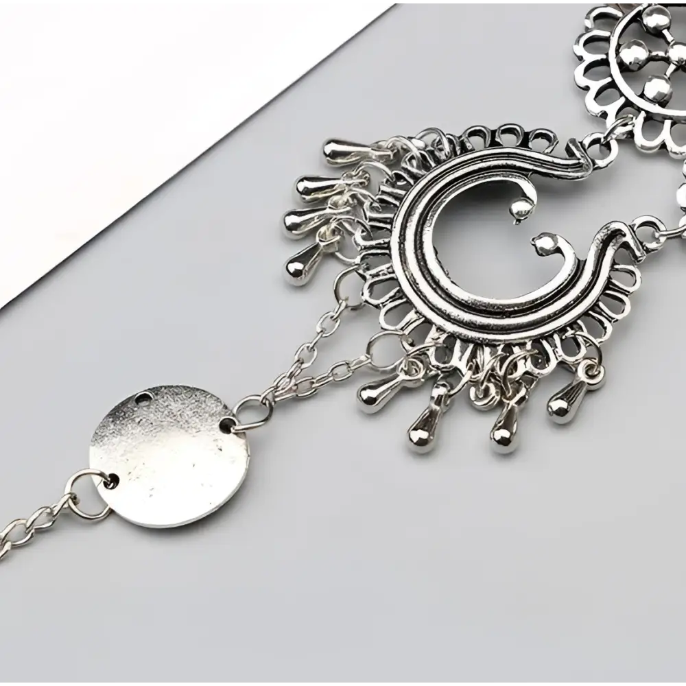 Silver-toned crescent moon pendant necklace with filigree and teardrop charms in bohemian jewelry antique style foot chain featuring flower design