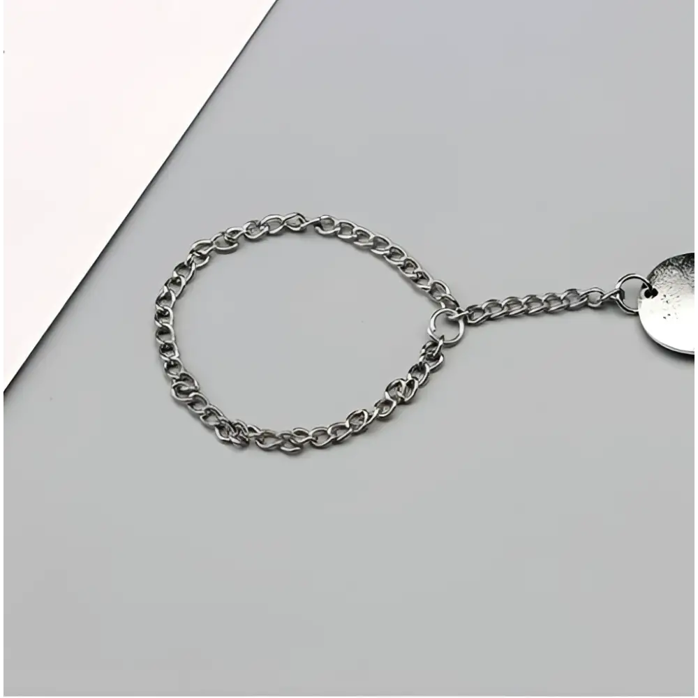 Silver-toned bohemian jewelry antique flower foot chain featuring a circular disc charm on a short link chain