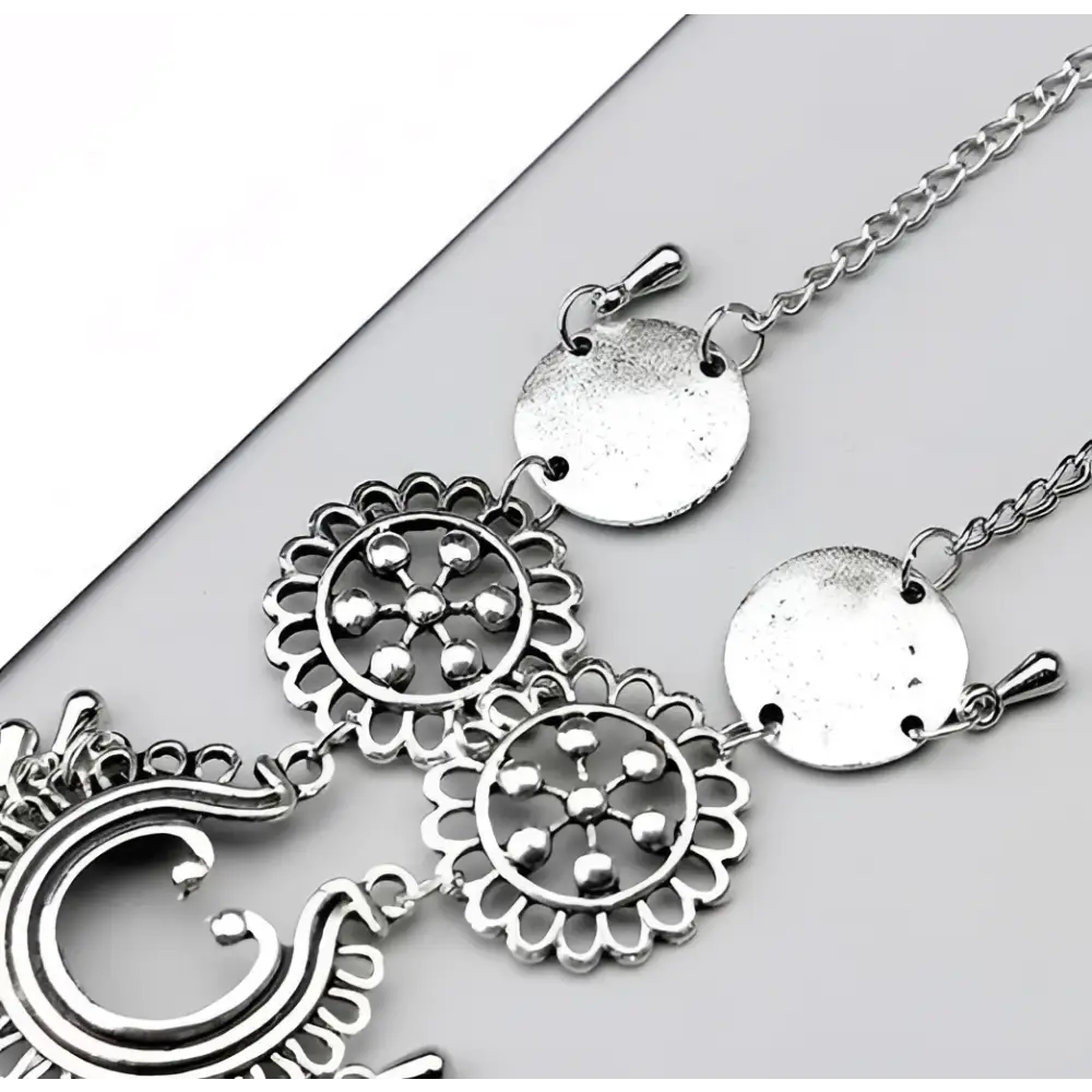 Silver-toned bohemian jewelry antique flower foot chain featuring intricate circular and crescent designs with dangling beads