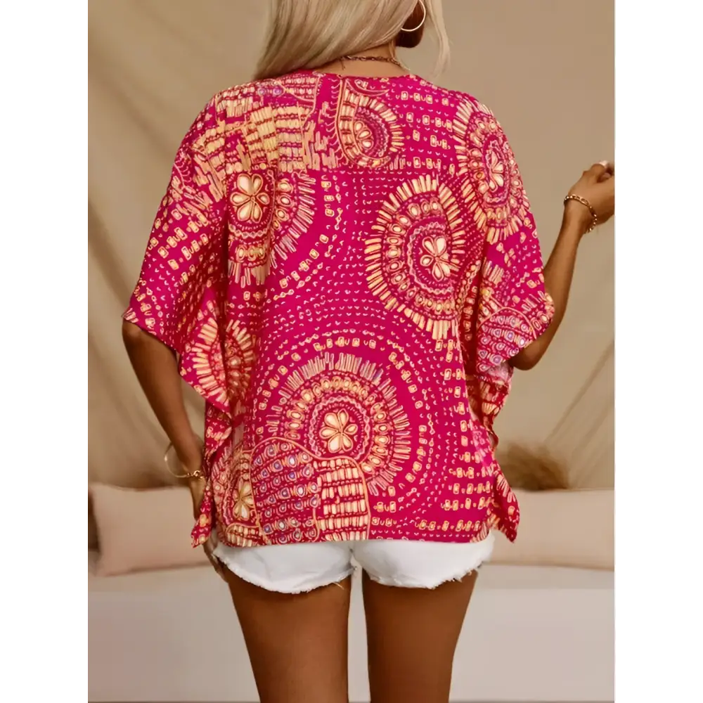 Vibrant orange bohemian-patterned top with white and blue geometric patterns and style batwing sleeve design