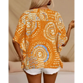 A vibrant orange bohemian-patterned batwing sleeve top with intricate white and blue circular designs for vacation style