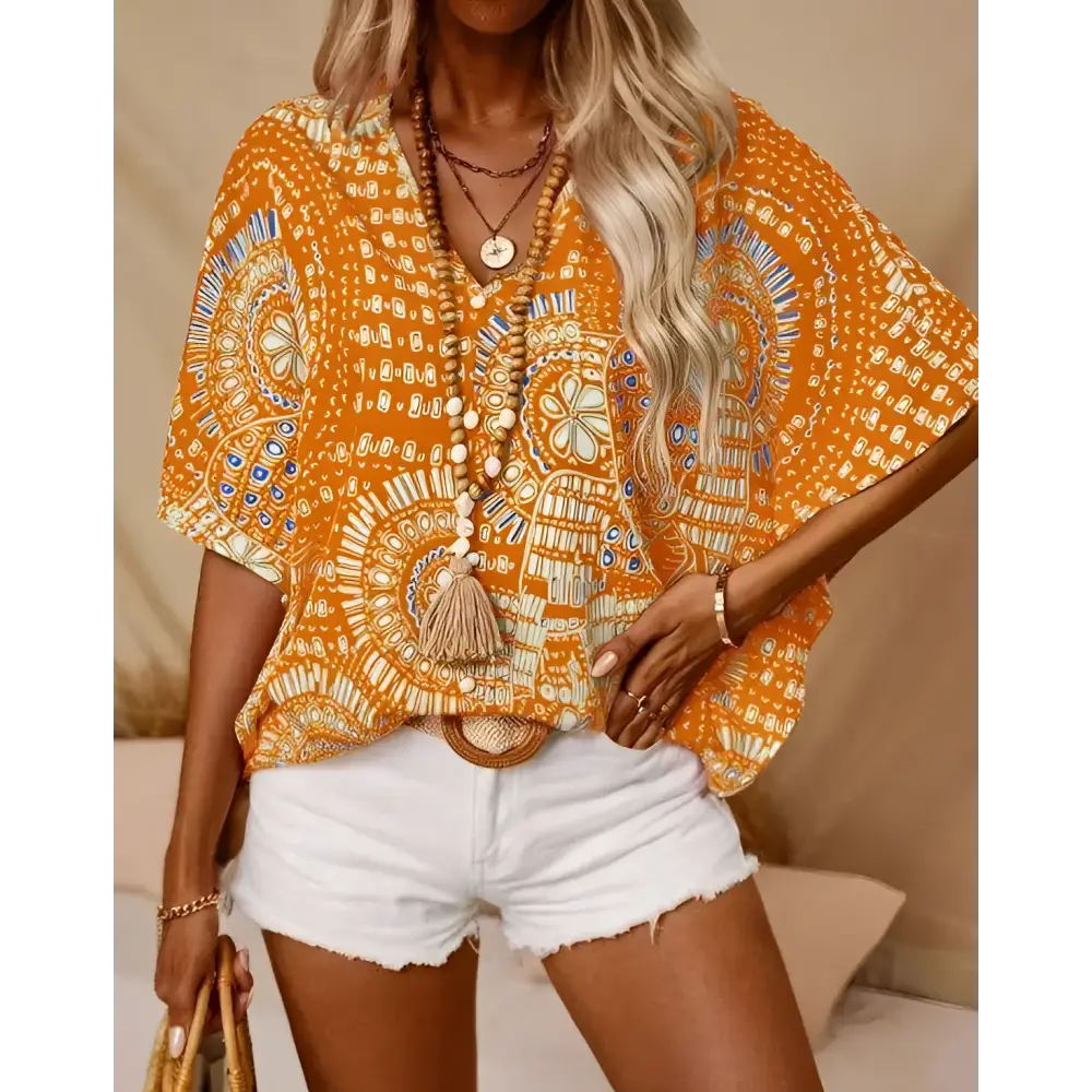 Orange bohemian-patterned short-sleeved top with white and blue accents featuring style batwing sleeve for vacation wear