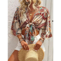 Bohemian style printed front tie crop top with vibrant paisley pattern in teal rust and cream and bell sleeves
