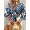 Bohemian style printed front tie crop top with vibrant blue and white paisley pattern and bell sleeves