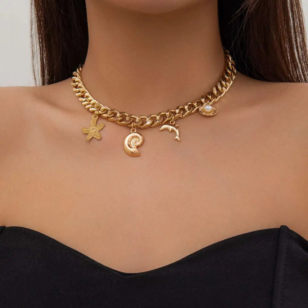 Gold-toned chunky chain choker necklace bracelet set with conch dolphin starfish and pearl charms in boho style