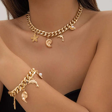 Gold-toned conch dolphin starfish choker necklace bracelet set with chunky chain and sea-themed charms including pearl accents