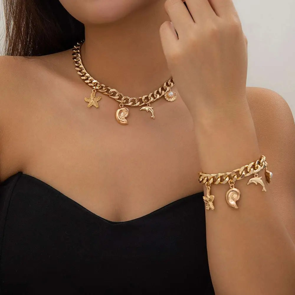 Gold-toned conch dolphin starfish choker necklace bracelet set with chunky chain and sea-themed charms including pearl accents