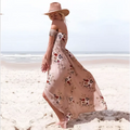 A boho style long off the shoulder maxi dress women floral in soft beige with intricate embroidery and flowing fabric