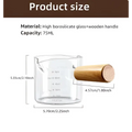 Clear borosilicate glass espresso measuring cup with wood handle and milliliter markings for precise use