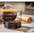 Borosilicate glass espresso measuring cup with wood handle and clear markings in milliliters and ounces