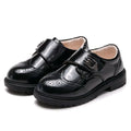 Boys black patent leather shoes with brogue detail velcro straps and chunky rubber sole in casual single style