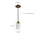 A modern brass and glass raindrop pendant light with an oval clear glass shade for contemporary elegance