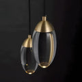 Brass and glass raindrop pendant lights featuring clear glass and gold-toned metal accents for contemporary elegance