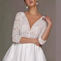 White lace bridal deep v-neck wedding dress with intricate floral patterns and three-quarter sleeve wedding dress design