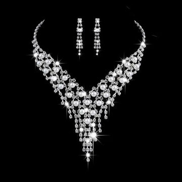 Bridal jewelry set featuring a sparkling silver pearl rhinestone necklace with cascading crystals and matching earrings