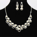 A sparkling silver bridal pearl and rhinestone jewelry two sets featuring cream pearls and matching drop earrings