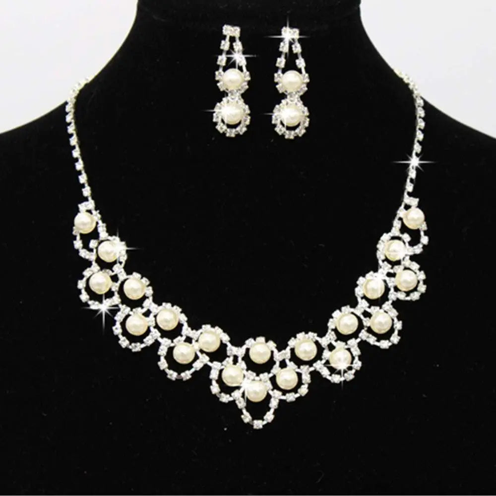 A sparkling silver bridal pearl and rhinestone jewelry two sets with cream pearls and matching drop earrings