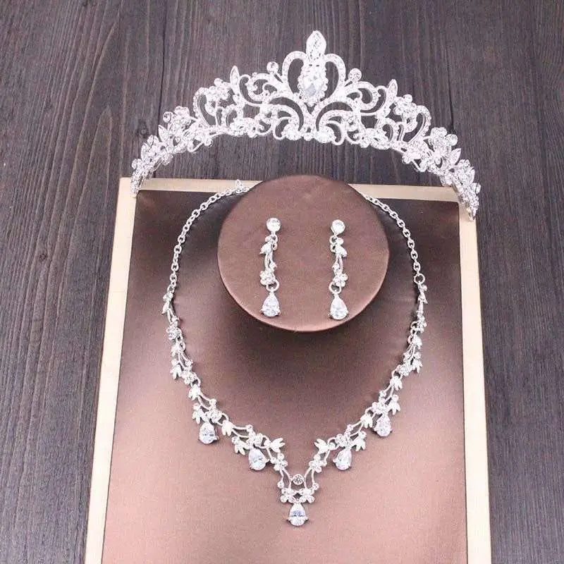 Silver bridal rhinestone crown necklace set with intricate floral and scrollwork design adorned with clear crystals