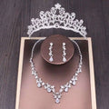 Silver bridal rhinestone crown with intricate floral and leaf designs adorned with sparkling rhinestones in a crown necklace set