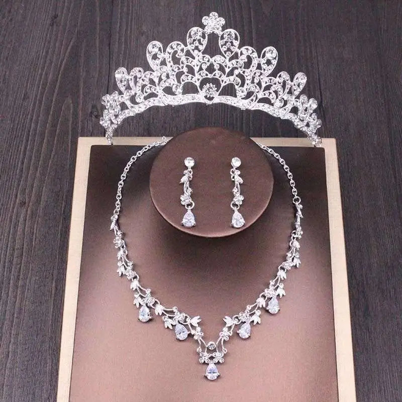 Silver bridal rhinestone crown with intricate floral and leaf designs adorned with sparkling rhinestones in a crown necklace set
