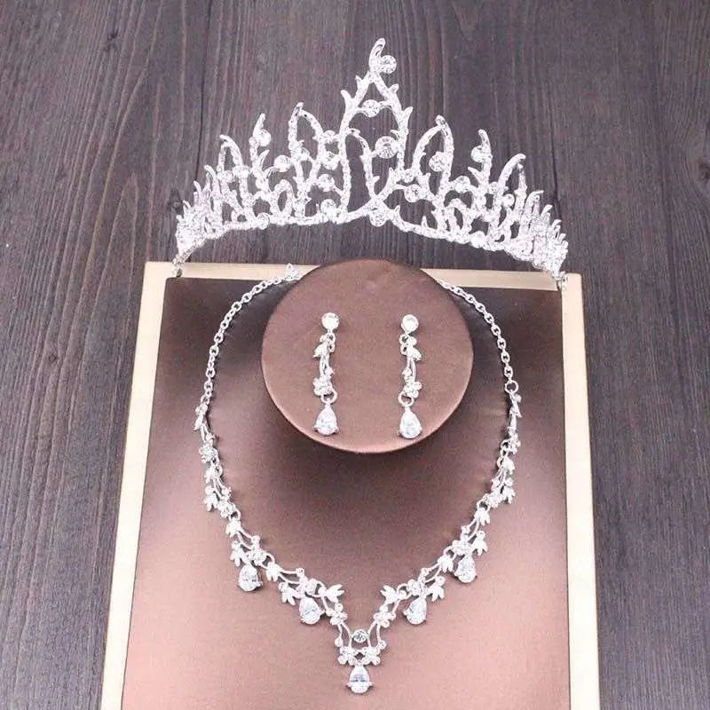 Silver bridal rhinestone crown with intricate floral design and sparkling rhinestones in crown necklace set