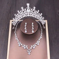 Silver bridal rhinestone crown with intricate floral crystal detailing and central teardrop gemstone in crown necklace set
