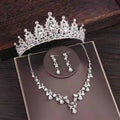 Silver bridal rhinestone crown featuring intricate floral designs and sparkling crystals in a crown necklace set