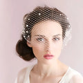 Delicate white bridal veil pearl with large hole mesh and small pearls on edges featuring a mesh hair comb