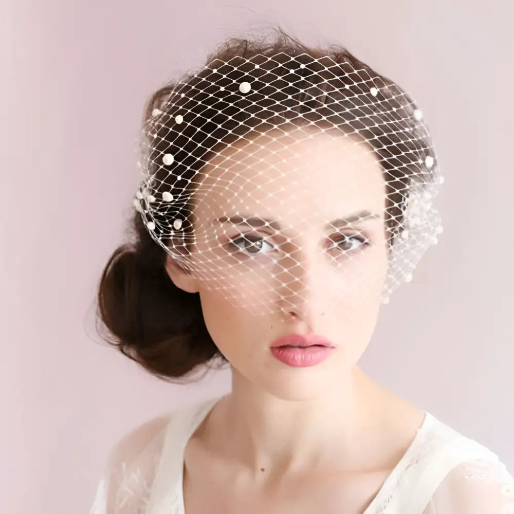 Delicate white bridal veil pearl with large hole mesh and small pearls on edges featuring a mesh hair comb
