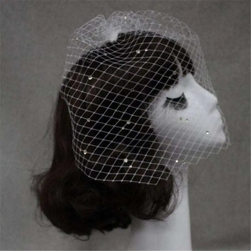 A delicate white bridal veil rhinestone large hole mesh headdress elegantly draped over a mannequin head