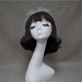 A delicate white bridal veil rhinestone with large hole mesh headdress draped elegantly on a mannequin head