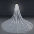 Bridal wedding veil with widened tail in delicate white sheer tulle fabric featuring a hair comb attachment