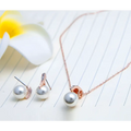 Rose gold bride rhinestone pearl earrings and necklace set featuring a single pearl pendant and matching studs