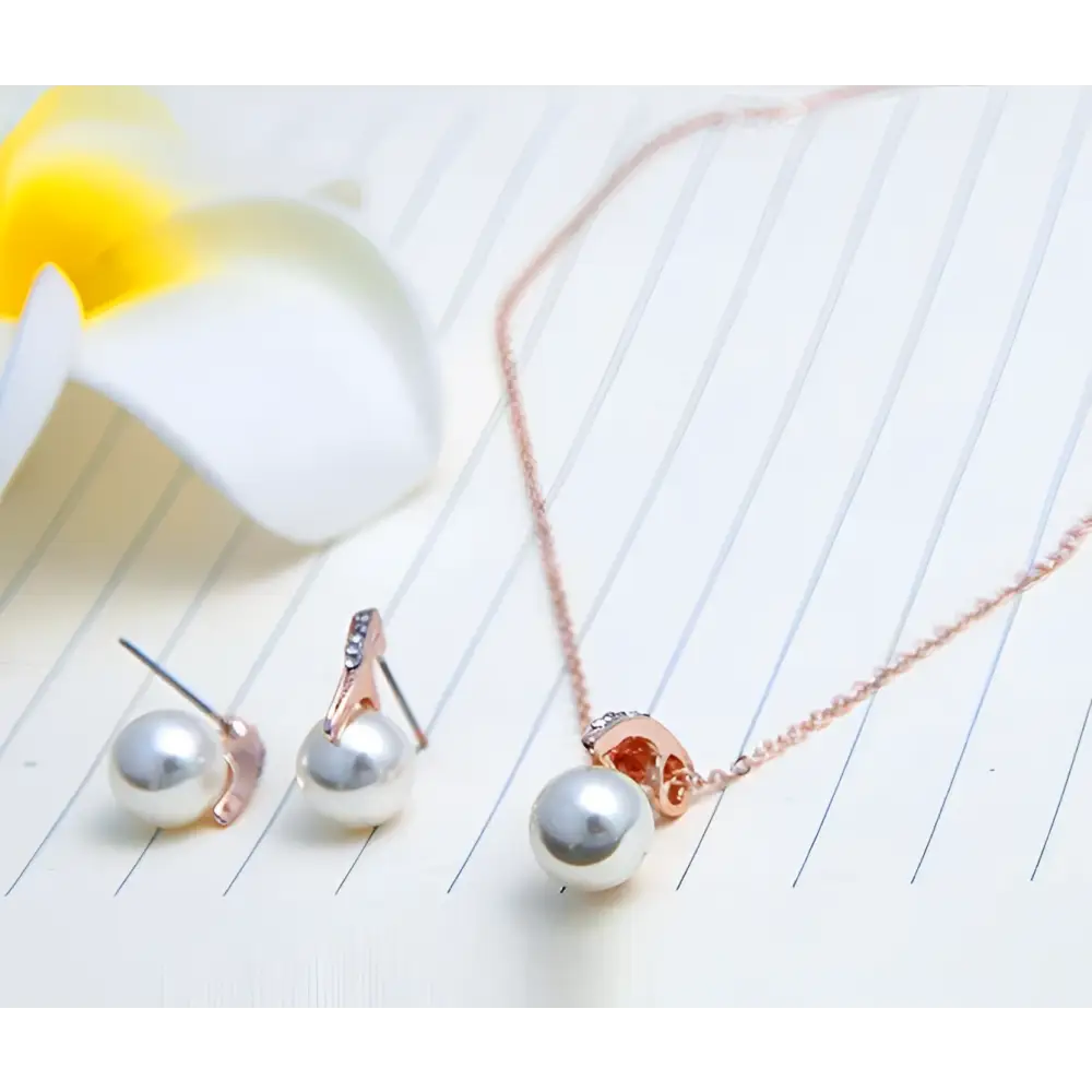 Rose gold bride rhinestone pearl earrings and necklace set featuring single pearl pendant and matching studs
