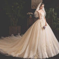 A bride summer tube top mori style trailing ivory gown with fitted bodice gold embroidery and flowing tulle skirt