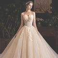 Strapless ivory bride summer tube gown with intricate gold lace and mori style trailing voluminous tulle skirt