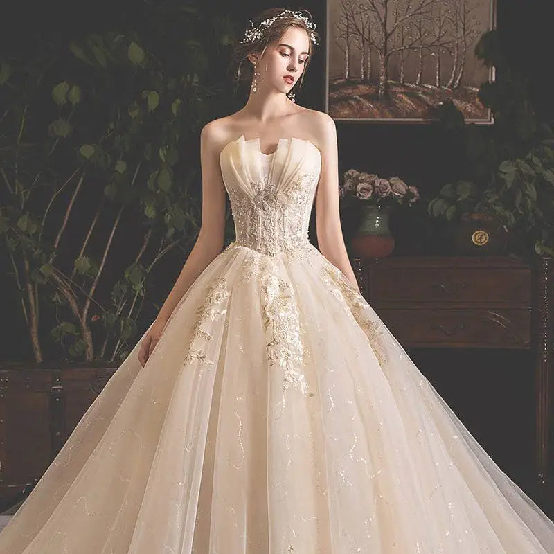 Strapless ivory bride summer tube gown with intricate gold lace and mori style trailing voluminous tulle skirt
