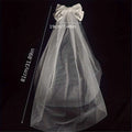 A delicate white tulle bridal veil with a white satin bow and bride to be embroidery for minimalism fashion wedding decoration