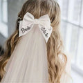 White satin bow hair clip with bride to be embroidered in black cursive for minimalism fashion wedding decoration