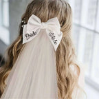 White satin bow hair clip with bride to be embroidered in black cursive for minimalism fashion wedding decoration