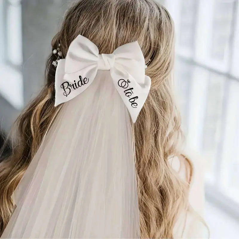 White satin bow hair clip with bride to be embroidered in black cursive for minimalism fashion wedding decoration