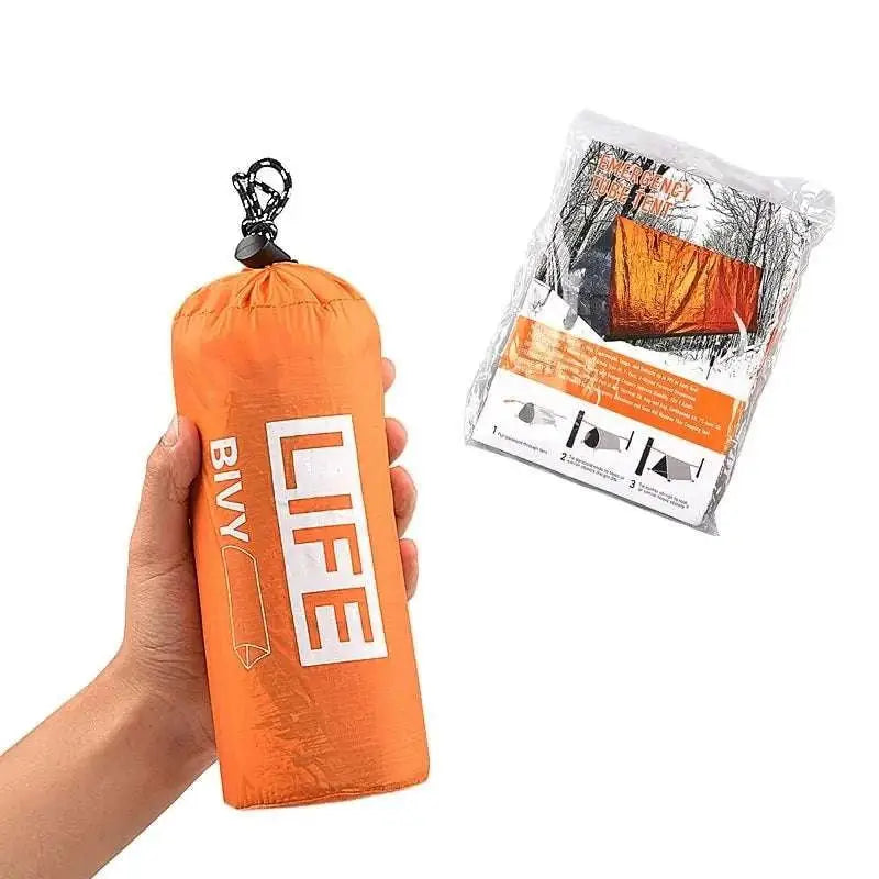 Bright orange survival tube emergency tent in stuff sack with life branding and built-in whistle for outdoor safety