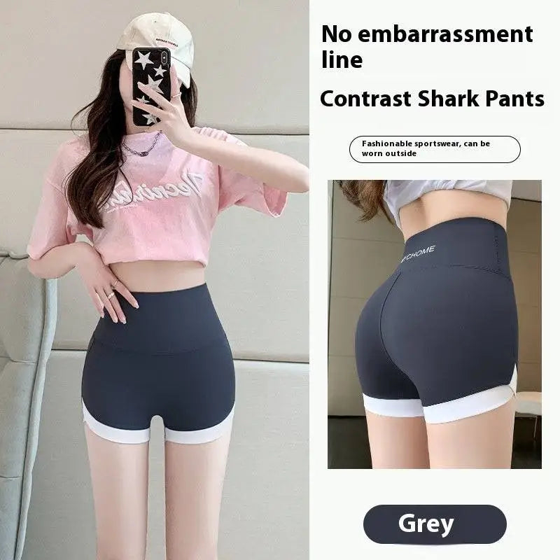 Grey contrast shark pants with white trim shown as hip lifting sports shorts with detailed stitching yoga pants design