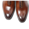 Polished brown leather oxford shoes for men with classic pointed toe and subtle tonal contrast ideal as wedding shoes